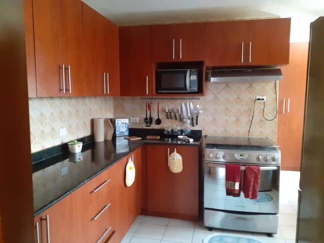 Kitchen with wood cabinets, granite countertops, stainless appliances in PH Torre Ebelle Bella Vista Panama
