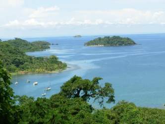 Scenic Caribbean coastline with boats and islands near Puerto Lindo land for sale