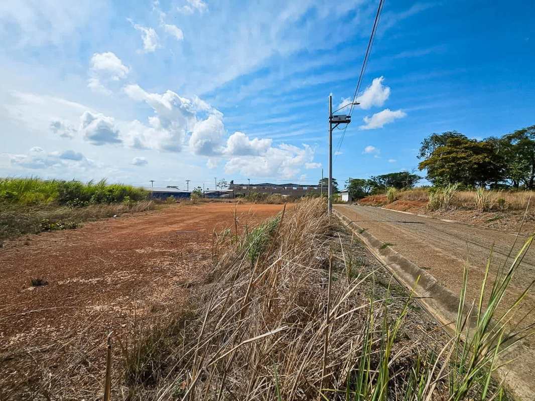 Corner vacant land beside paved road utility poles and clear sky in Pacora Chepo Panama
