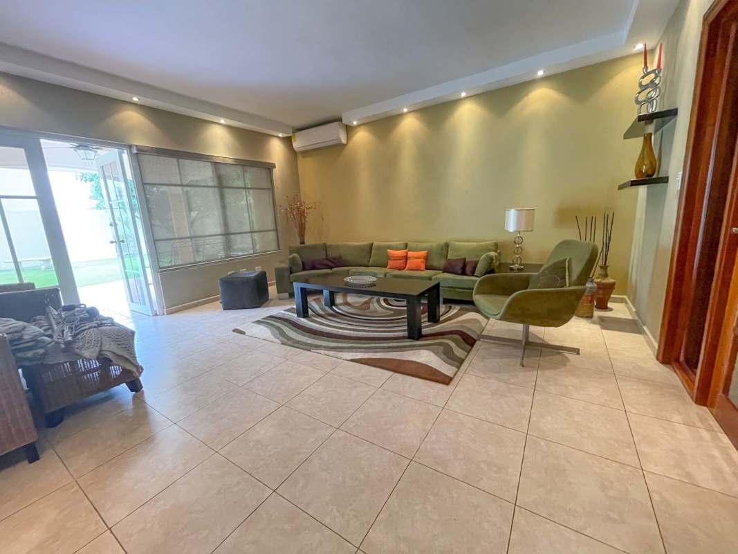 Living room with sofa set, large windows and tile floors Palmeras del Este Panama
