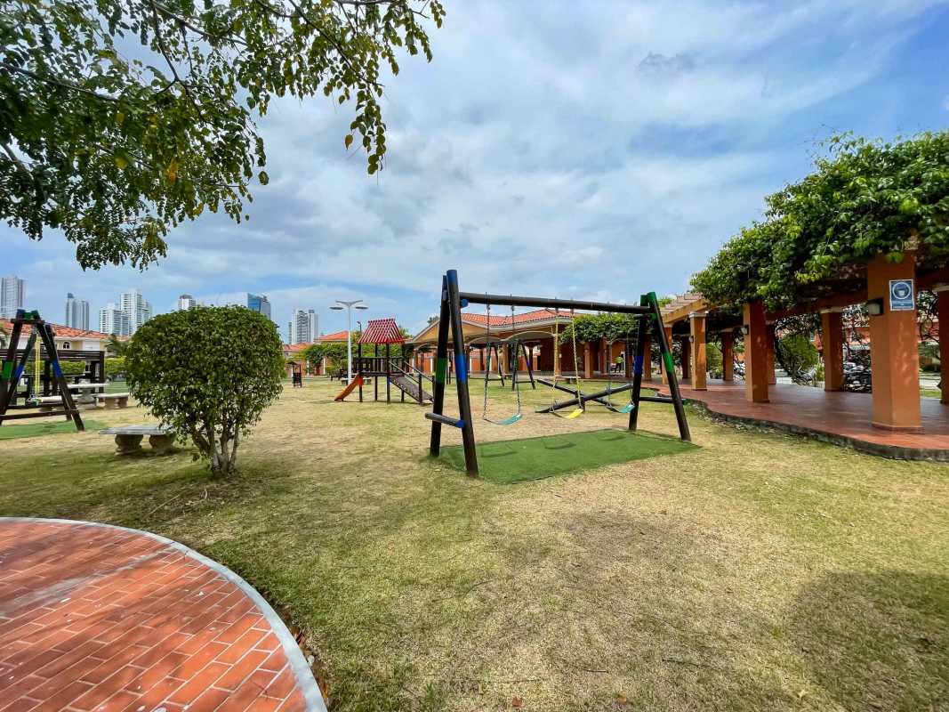Colorful children's playground surrounded by landscaping Palmeras del Este