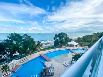 Infinity swimming pool beachfront ocean view palm trees Santa Clara Residences Panama
