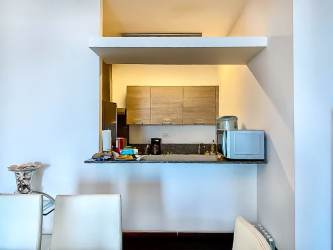 Open concept kitchen granite countertop dining area apartment Santa Clara beach Panama