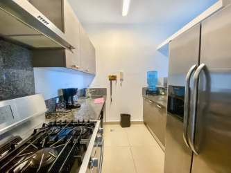 Modern kitchen stainless steel appliances granite countertop Santa Clara Residences beachfront condo Panama