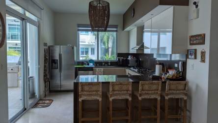 Bright open living dining area with modern kitchen and ocean-view windows in PH Bijao Beach Residences Panama