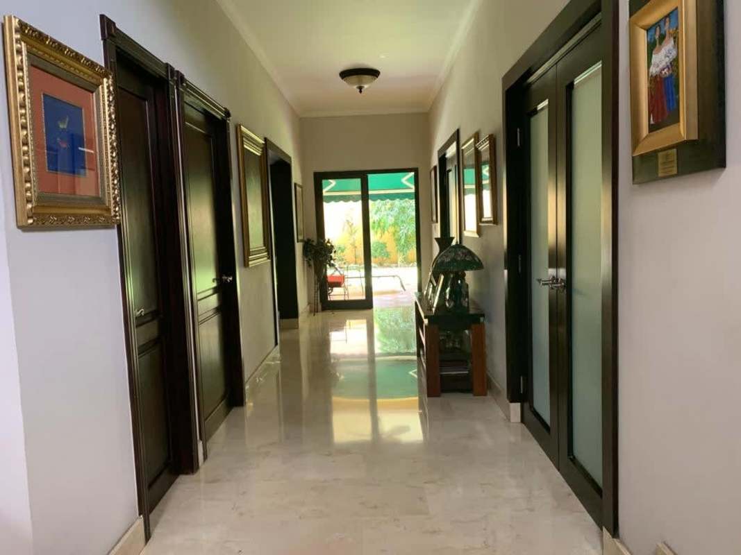 Spacious modern kitchen with granite counters and wooden cabinets in Antigua Costa del Este Panama