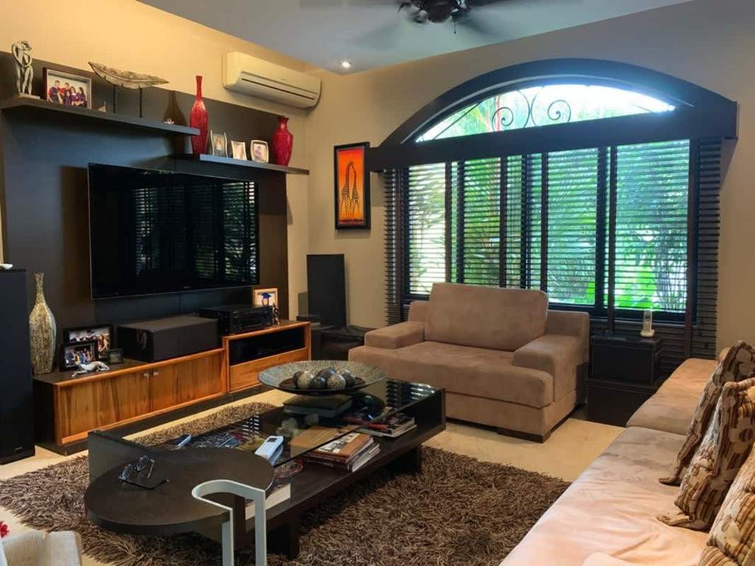 Luxury home living area with large window, entertainment center, garden views in Antigua Costa del Este Panama
