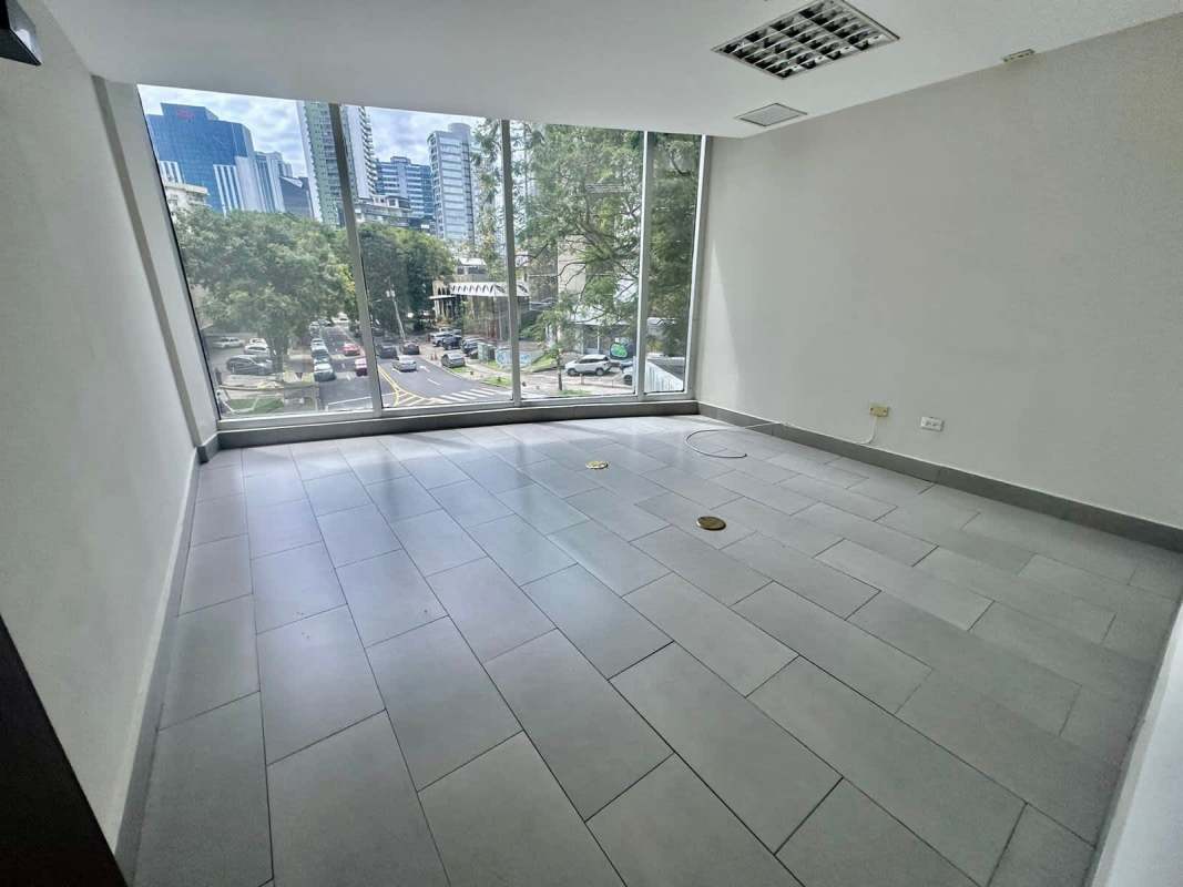 Empty open-plan office space with large city view windows in PH Denovo Obarrio Panama City