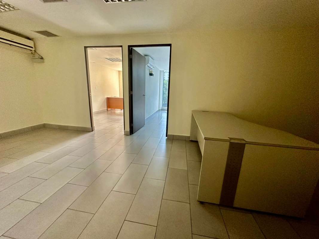 Open coworking area with AC tiled floors and partitioned spaces in PH Denovo