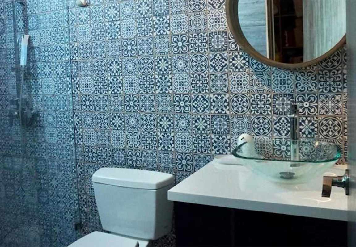 Modern bathroom with patterned tiles, glass shower enclosure, vessel sink Pacific Village Tower 2 Panama City