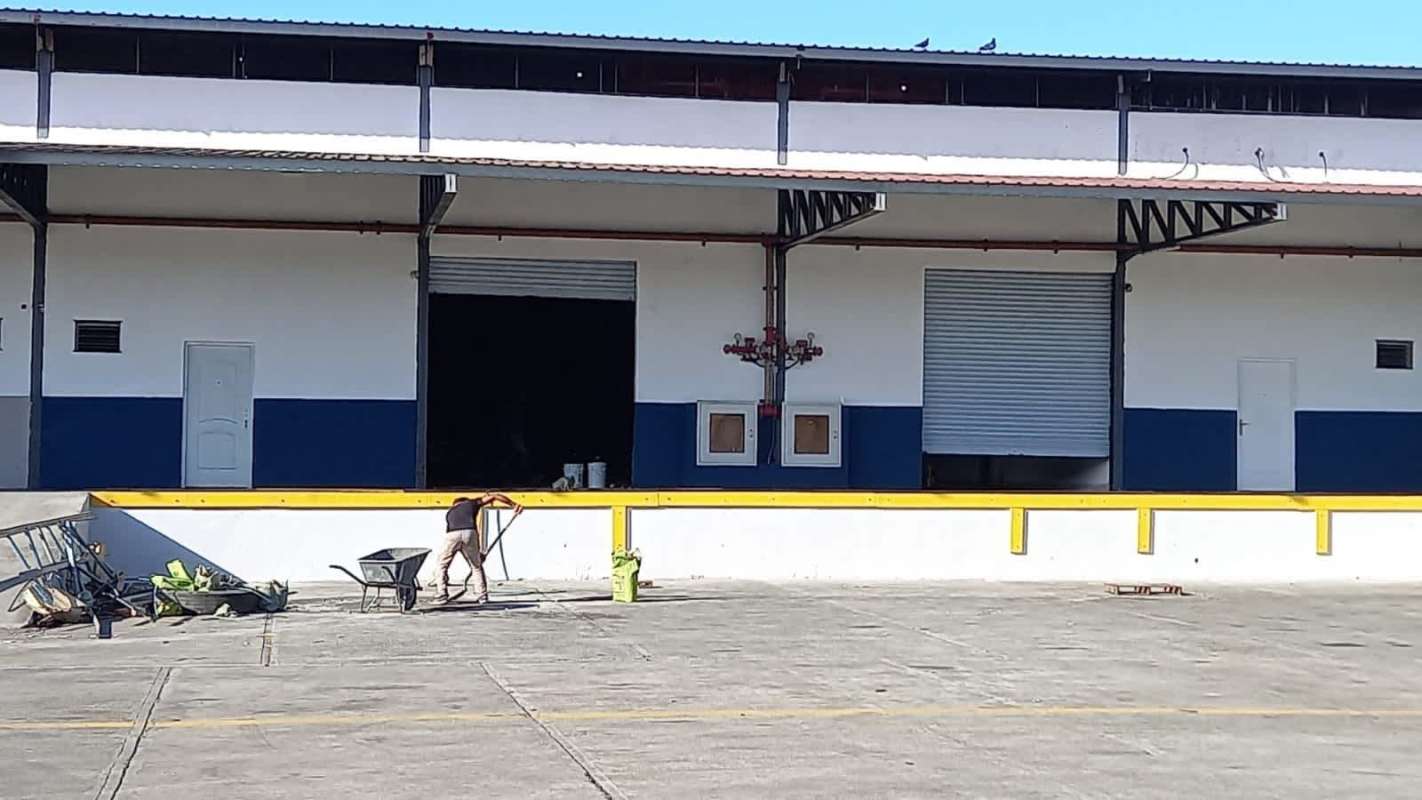 Exterior loading dock area of industrial warehouse with rolling doors and truck access at Tocumen Logistic Center Panama