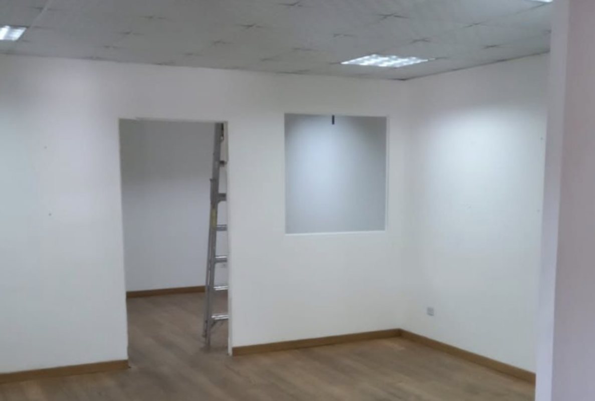 Partitioned office space inside warehouse with white walls drop ceiling and wood flooring Tocumen Logistic Center Panama