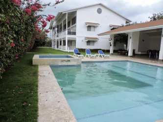Living room in beachfront condo with access to private balcony overlooking gardens