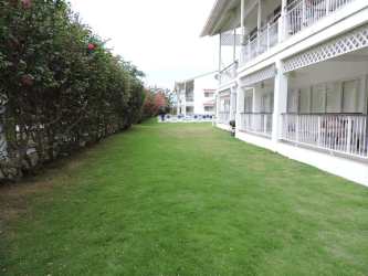 Two story colonial-inspired condo buildings with balconies at Kite Village Punta Chame