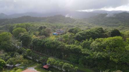 Property entrance driveway surrounded by lush landscape and covered porch roof Portobelo Panama