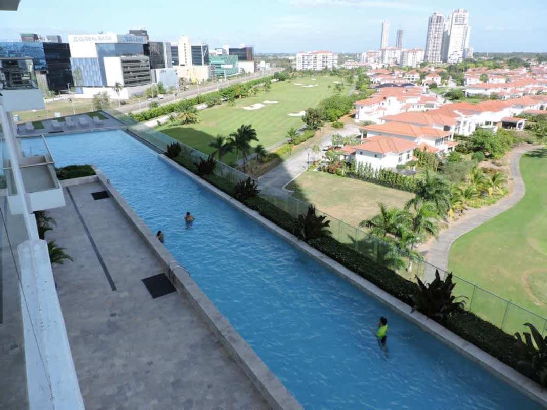 Contemporary kitchen with stainless steel countertops, appliances, large window PH Greenview Residences Panama