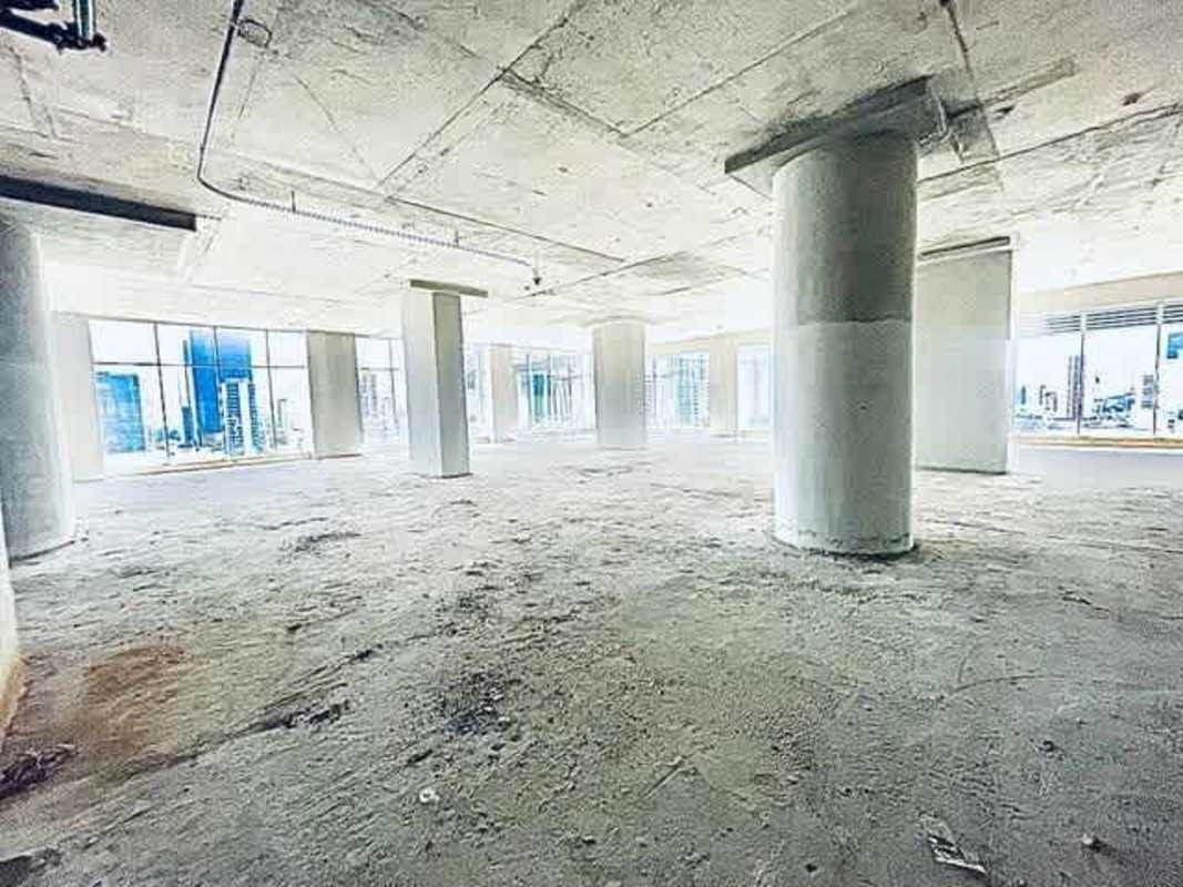 Interior unfinished office with large windows overlooking Panama City financial district in Revolution Tower
