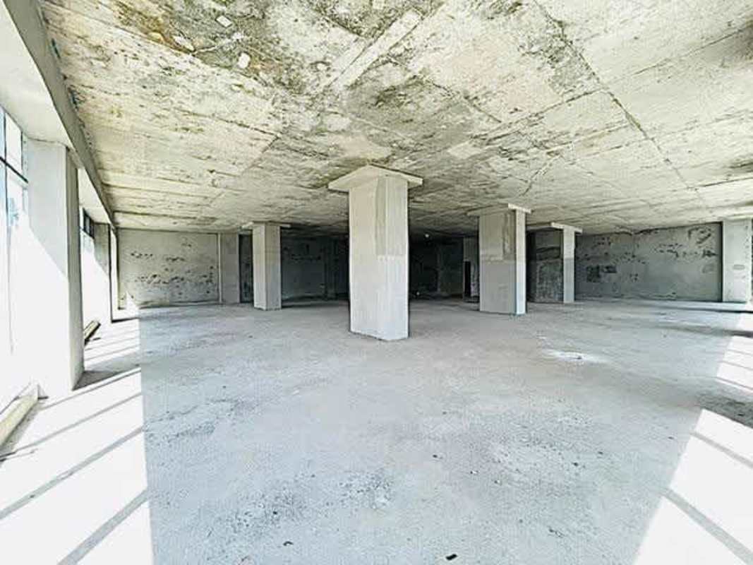 Unfinished large office floor in Revolution Tower Panama with exposed structure and glass façade