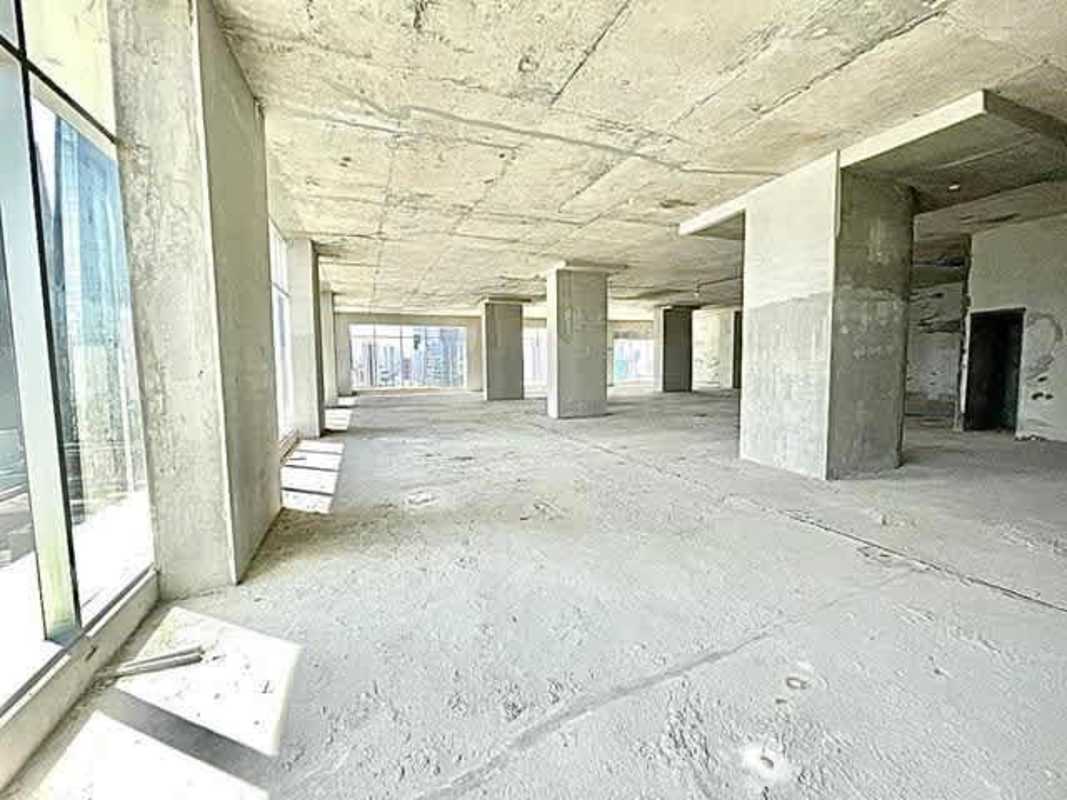 Exposed concrete walls and columns inside shell condition office space in Revolution Tower Panama