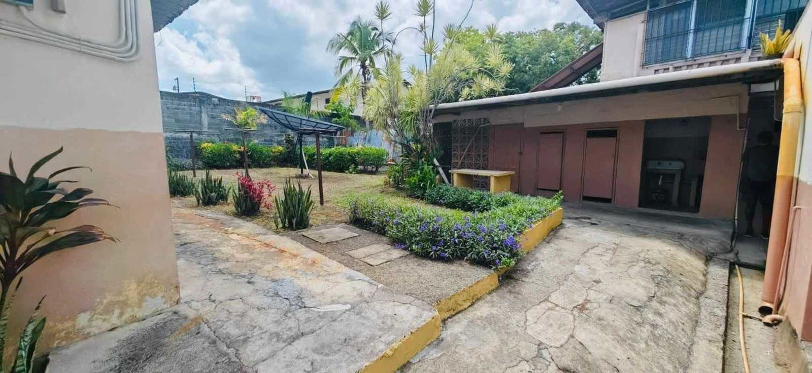 Concrete patio backyard with greenery and utility area in commercial income property Panama