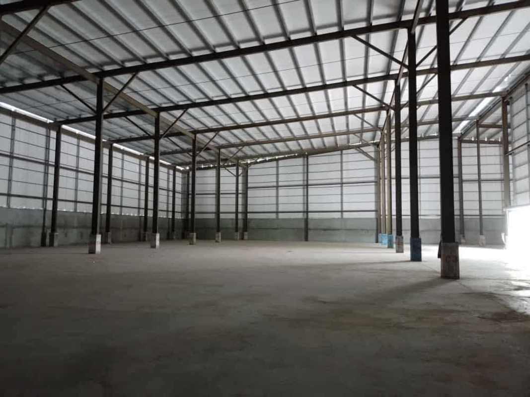 Industrial warehouse loading docks with metal canopy and roller doors