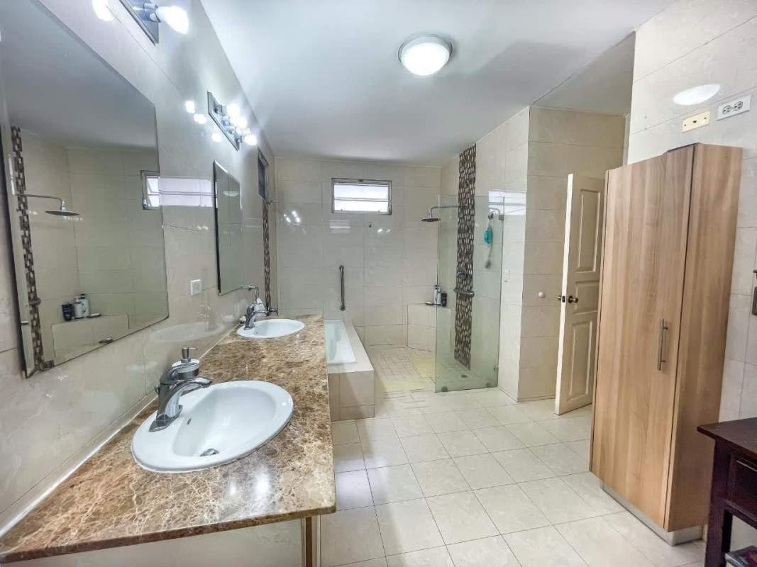 Spacious master bedroom with balcony access in luxury house for sale San Francisco Panama