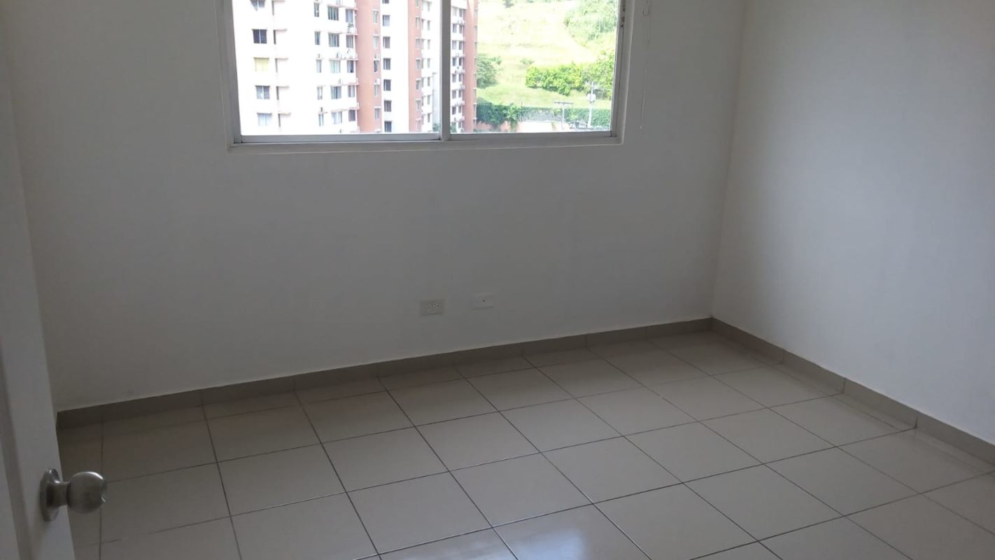 Bedroom with large window tiled floor white walls apartment for sale PH Mallorca Park Panama