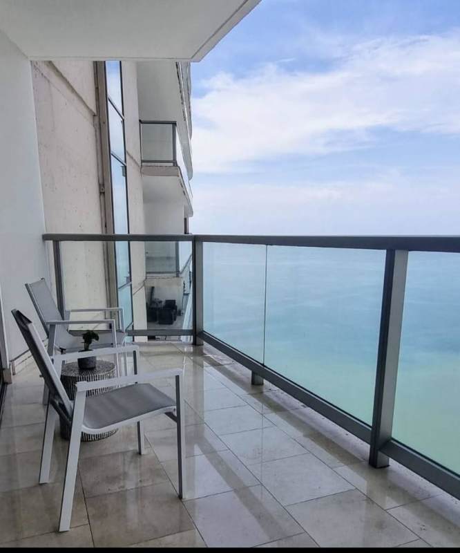 Spacious furnished balcony with glass railing and Pacific Ocean view at PH Pacific Point in Punta Pacifica Panama