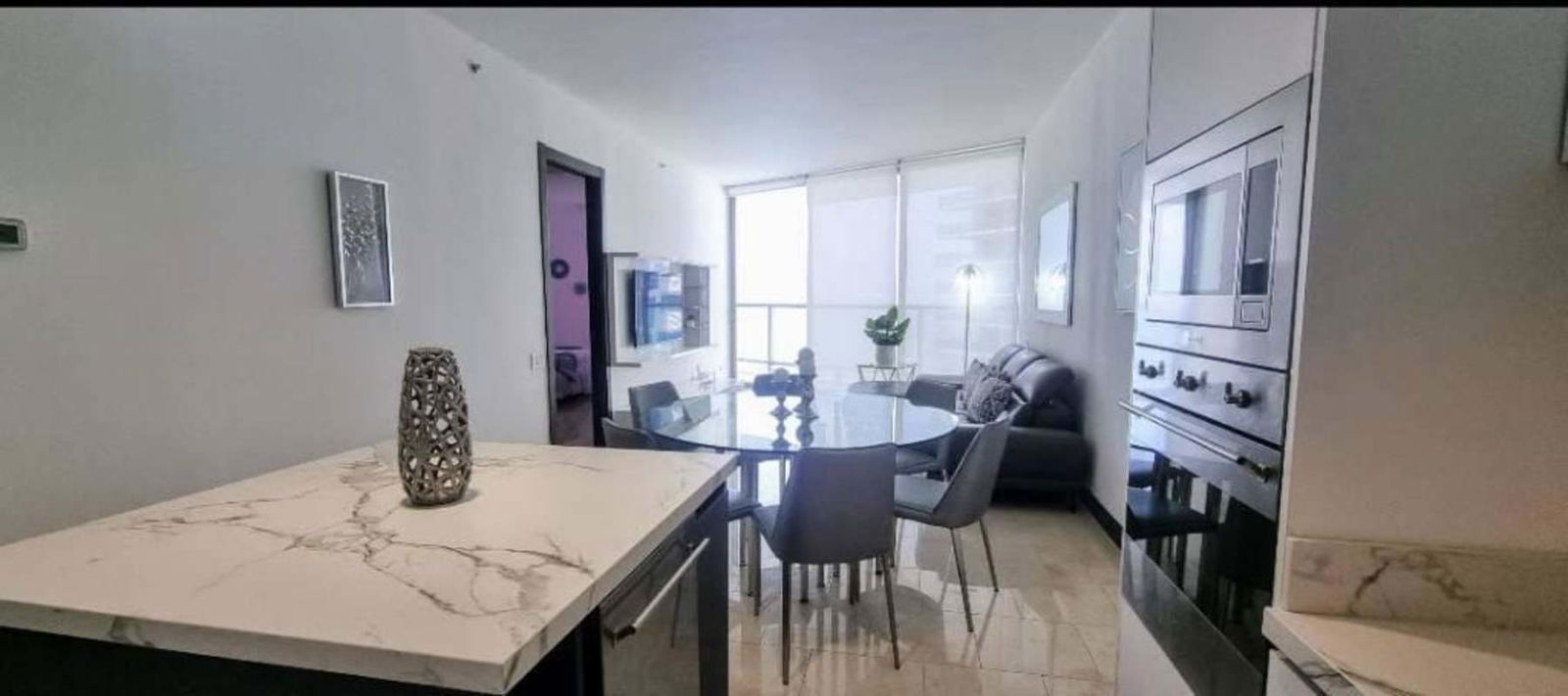 Modern bathroom with glass-enclosed shower marble vanity and upscale fixtures at PH Pacific Point