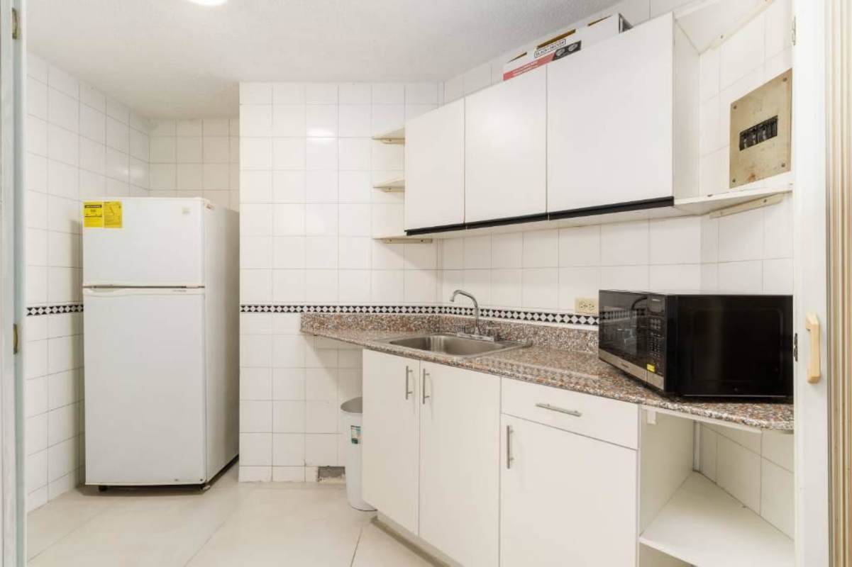 Compact kitchen with granite countertop, appliances ready in Horizonte Tower El Cangrejo Panama