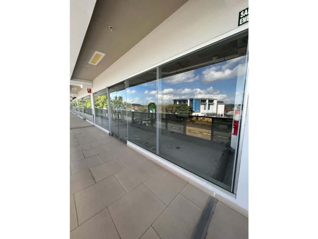 Walkway with floor tiles and glass windows in a modern shopping complex PH Terrazas de Albrook Panama