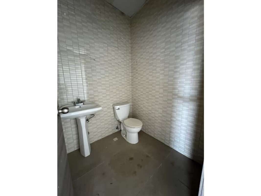 Modern glass exterior of PH Terrazas de Albrook commercial building with covered walkway and colorful panels Panama