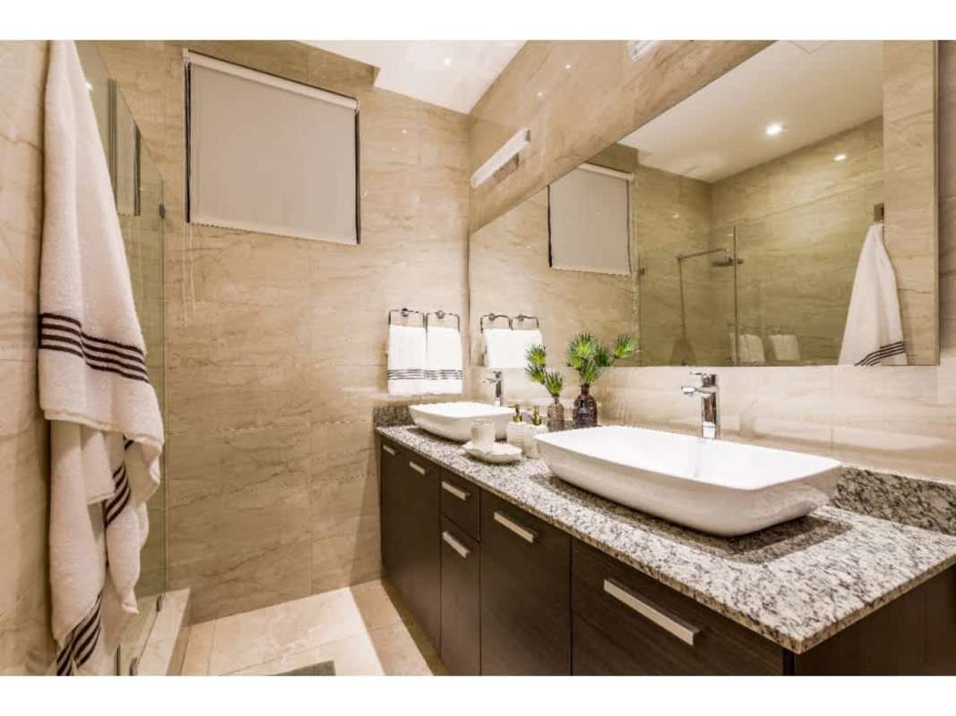 Bathroom with double vessel sinks, granite vanity, large mirror PH Deluxe Residences Punta Paitilla Panama