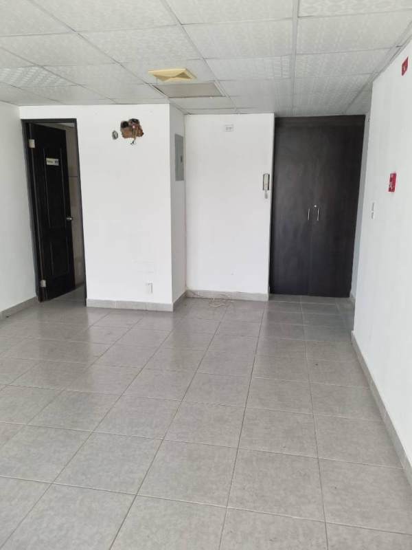 Empty open commercial interior space with tiled flooring and large windows at PH Madison Tower