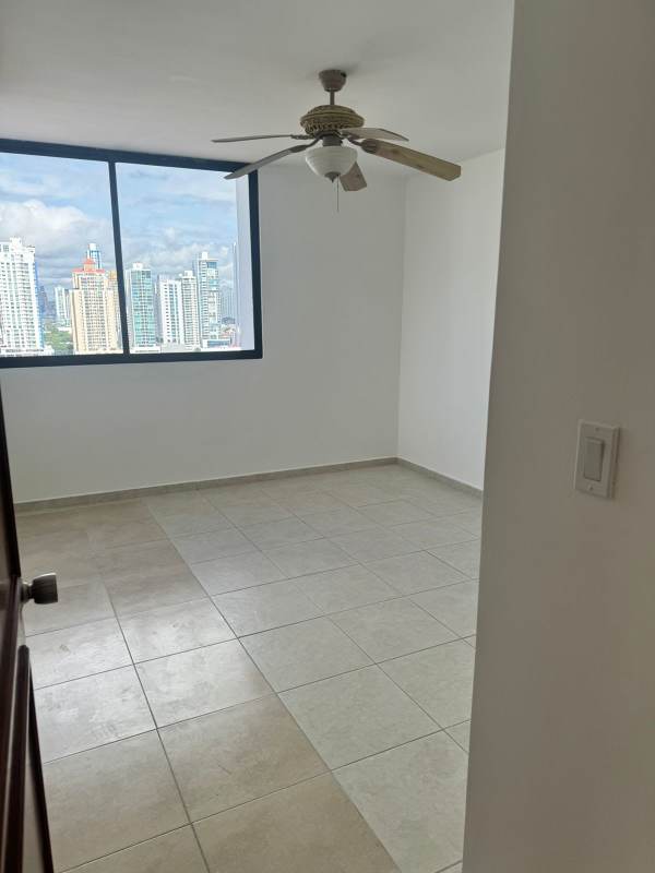 Spacious living and dining area with large windows and balcony access overlooking ocean at PH Lexus Tower