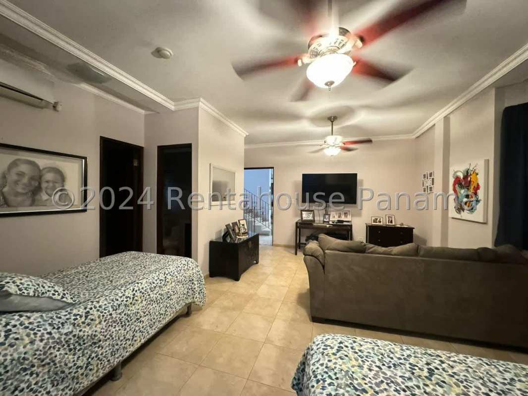 Spacious living room with large windows, tile floors, ceiling fans in El Carmen Panama