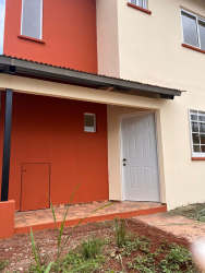 Kitchen with L-shaped counters, white cabinetry Villas Altos Panamá Oeste house