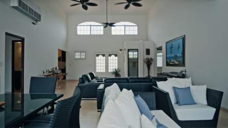 Spacious kitchen with granite countertops, dark wood cabinetry in Coronado Panama beach house