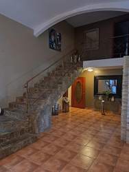 Gated entrance with stone walls and red-roof gazebo at El Valle estate property Panama
