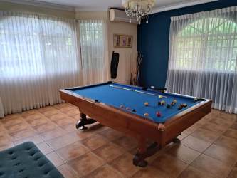 Game room with pool table and windows overlooking garden El Valle Panama