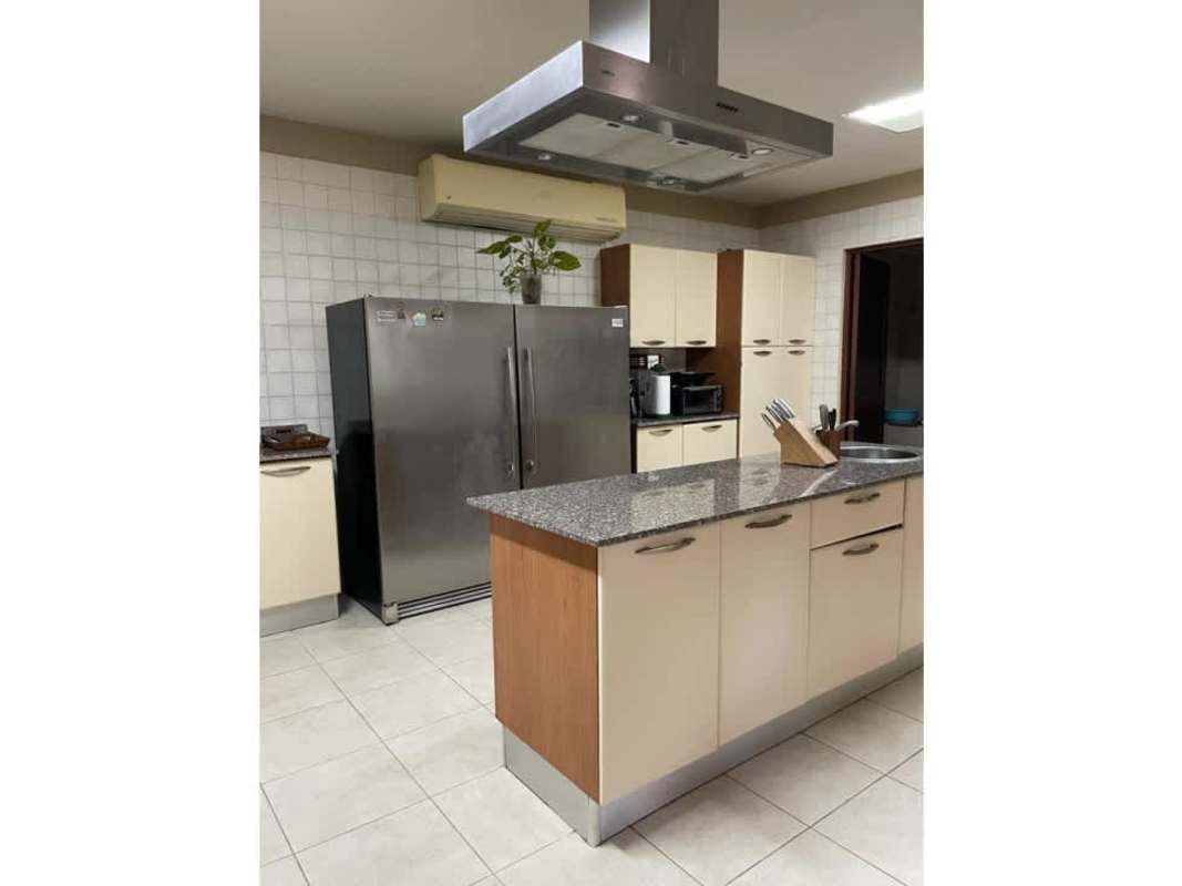 Spacious double height ceiling living room with large windows and modern decor for sale in Clayton Panama