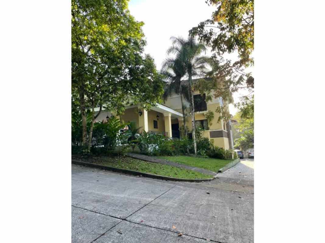 Two-story contemporary house with front porch surrounded by lush gardens in Clayton Panama for sale