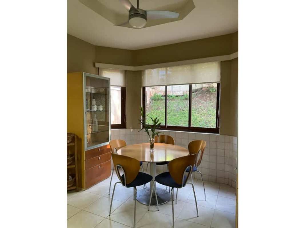 Elegant dining room with large windows and pendant lighting luxury house in Clayton Panama