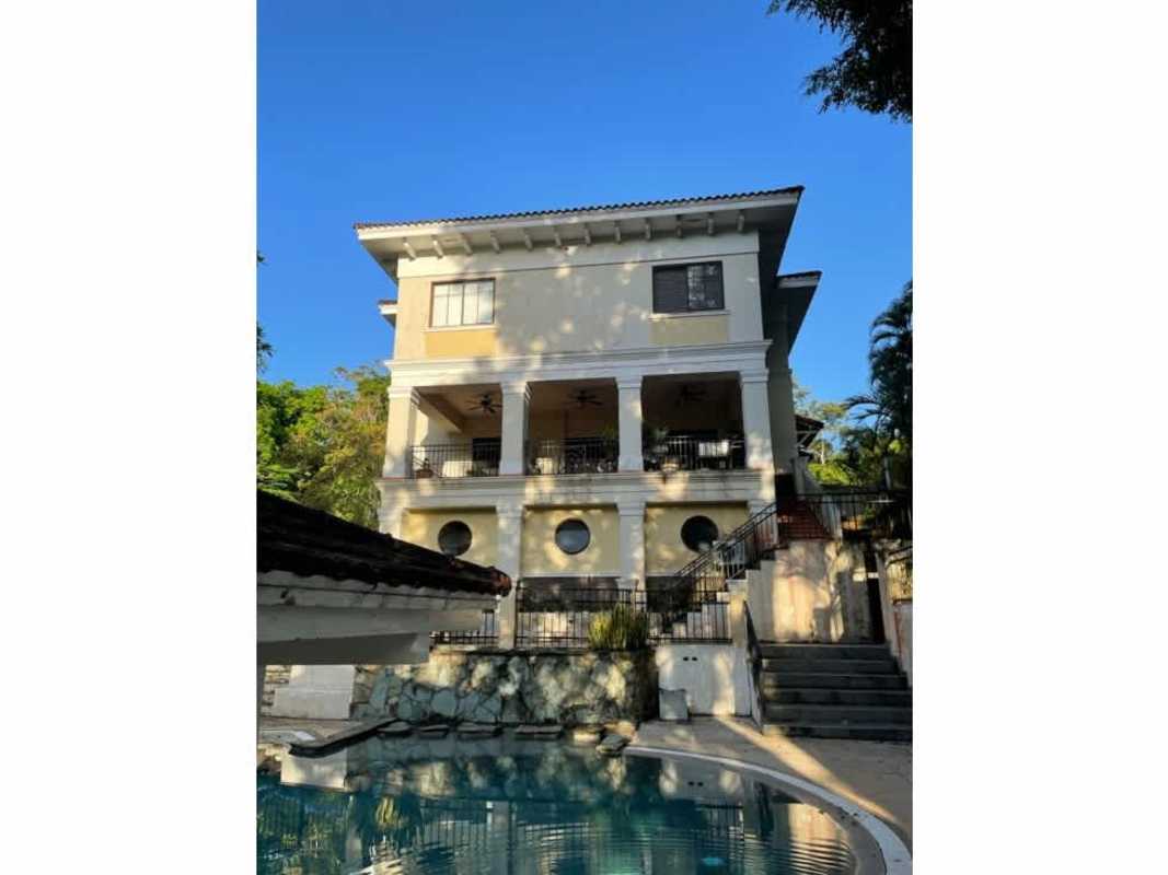 Swimming pool with bohio gazebo surrounded by garden in Camino de Cruces luxury house Clayton Panama