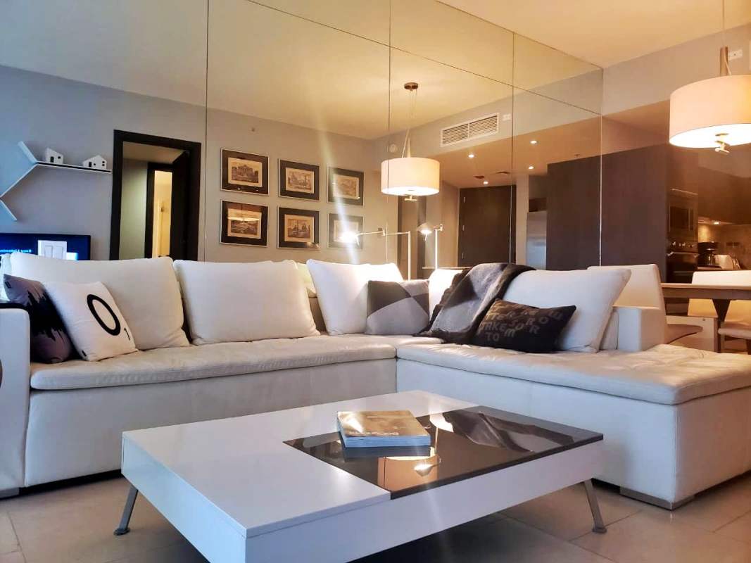 Furnished living and dining room with balcony and ocean views in JW Marriott Panama Punta Pacifica