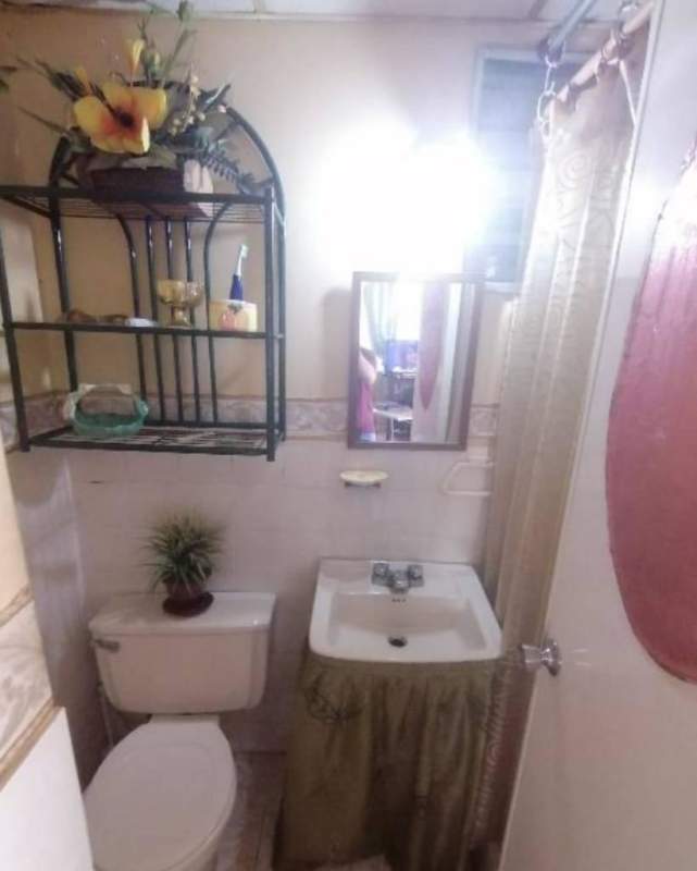 Living area with tiled floors, ceiling fan, beige walls and staircase in Pradera del Rocio Villa Zaita Panama