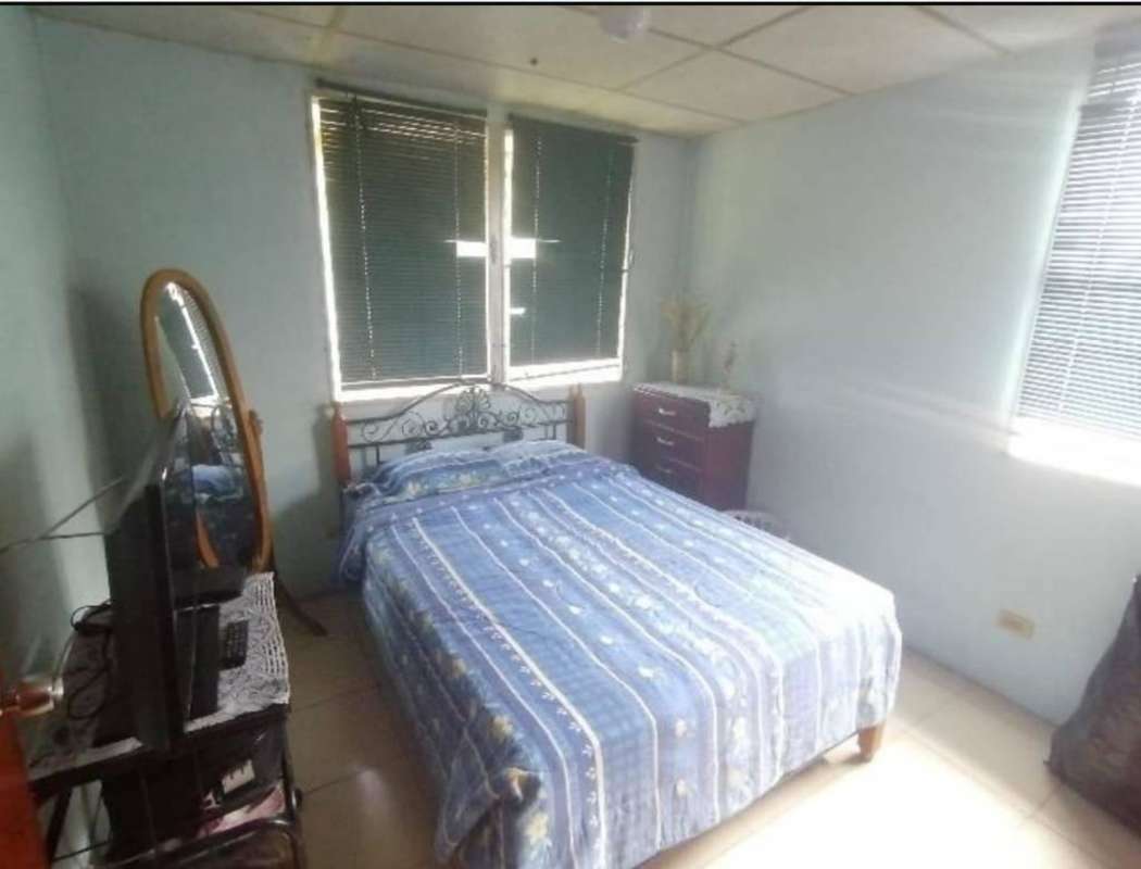 Compact bathroom with pedestal sink, toilet, window and shower with curtain in Pradera del Rocio Panama