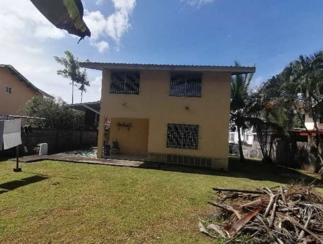 Detached two-story house with backyard lawn, utility area, palm trees in Pradera del Rocio Panama