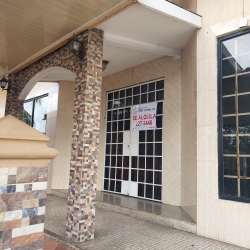 Open layout interior of empty retail unit with large glass block windows and fire extinguisher in Costa Verde La Chorrera Panama