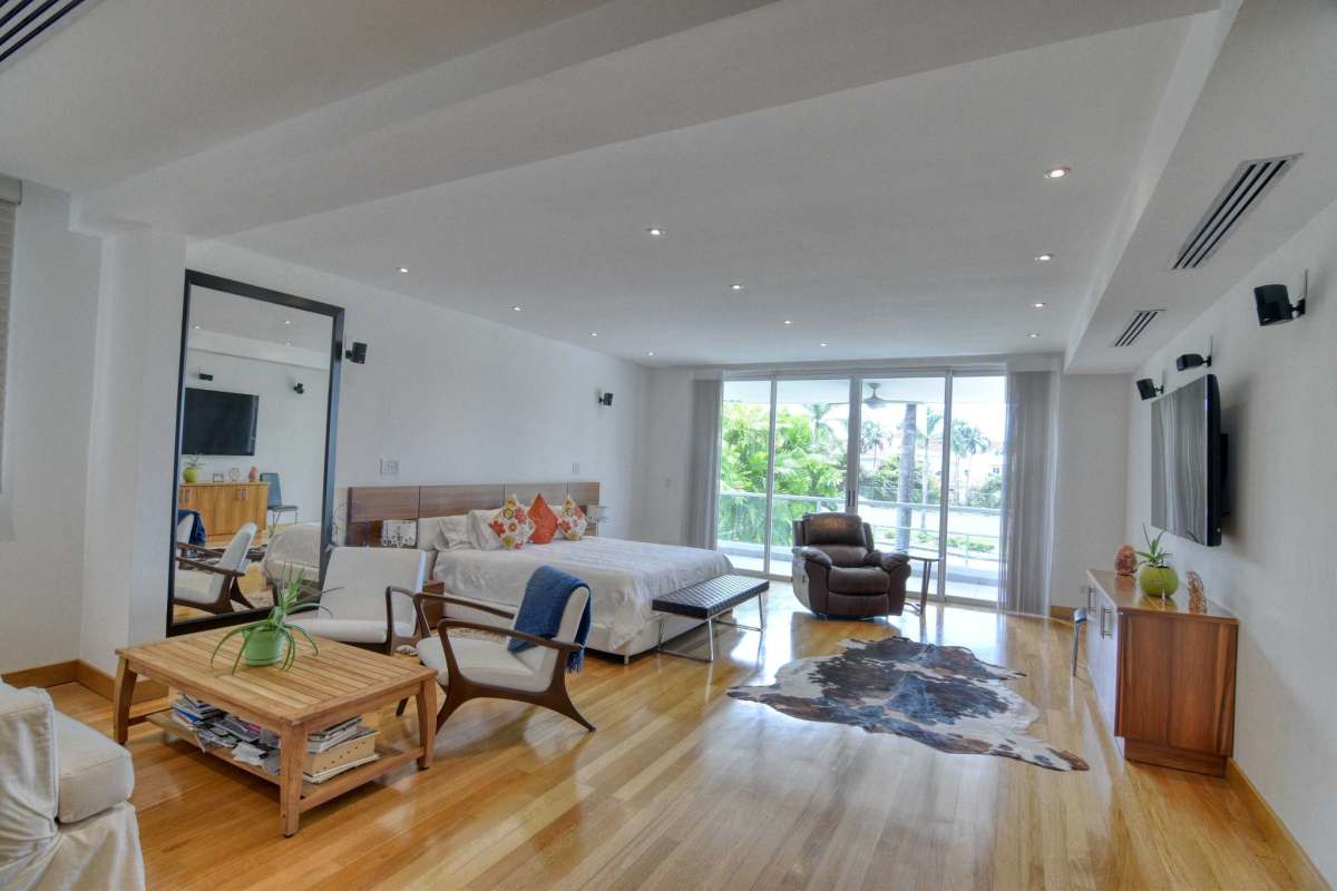 Spacious kitchen with marble counters, wood cabinetry, and modern appliances